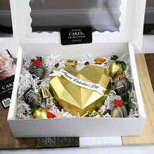 Load image into Gallery viewer, Gold chocolate breakable heart with chocolate strawberries.
